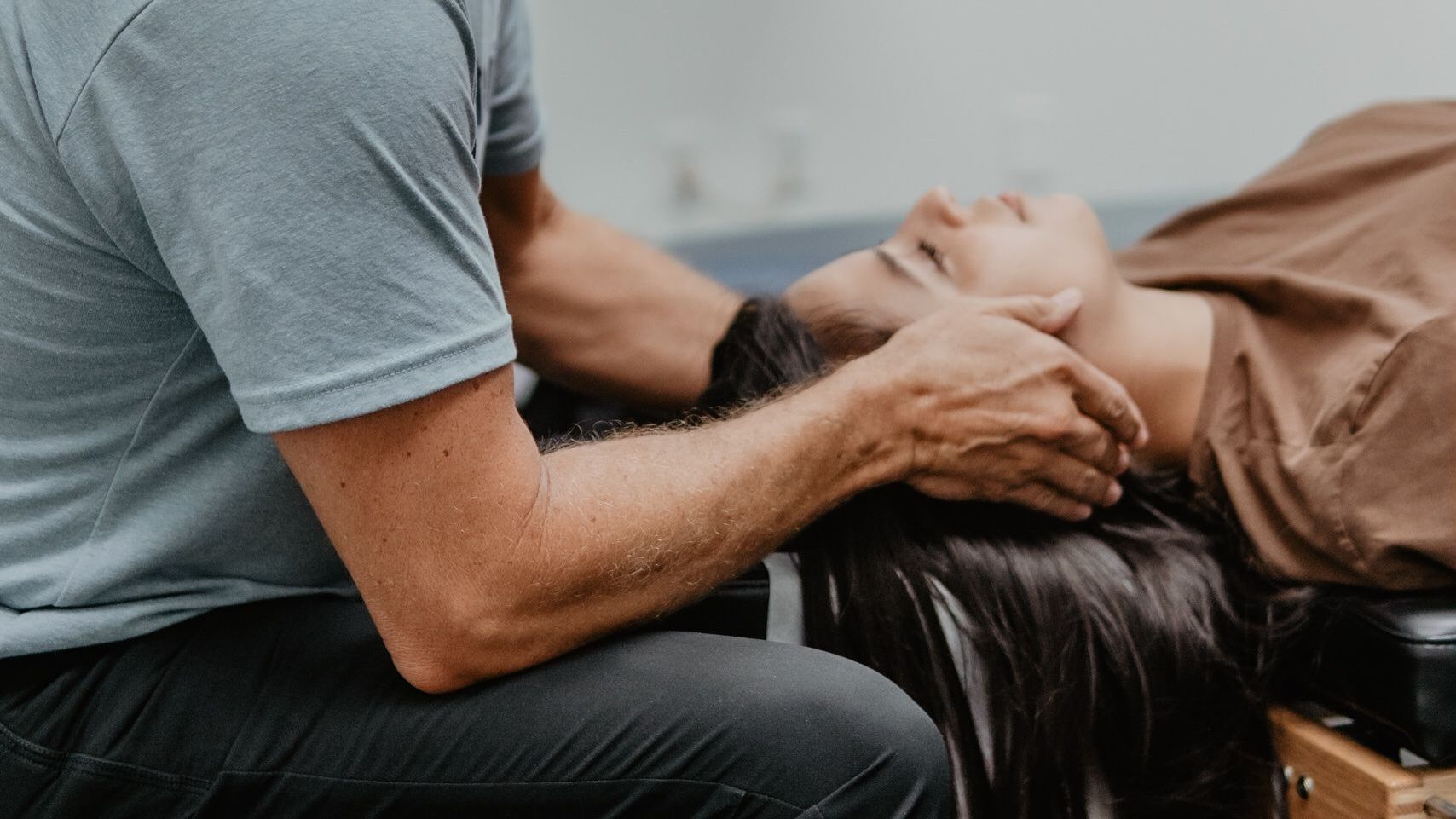 A man is giving a woman a head massage.