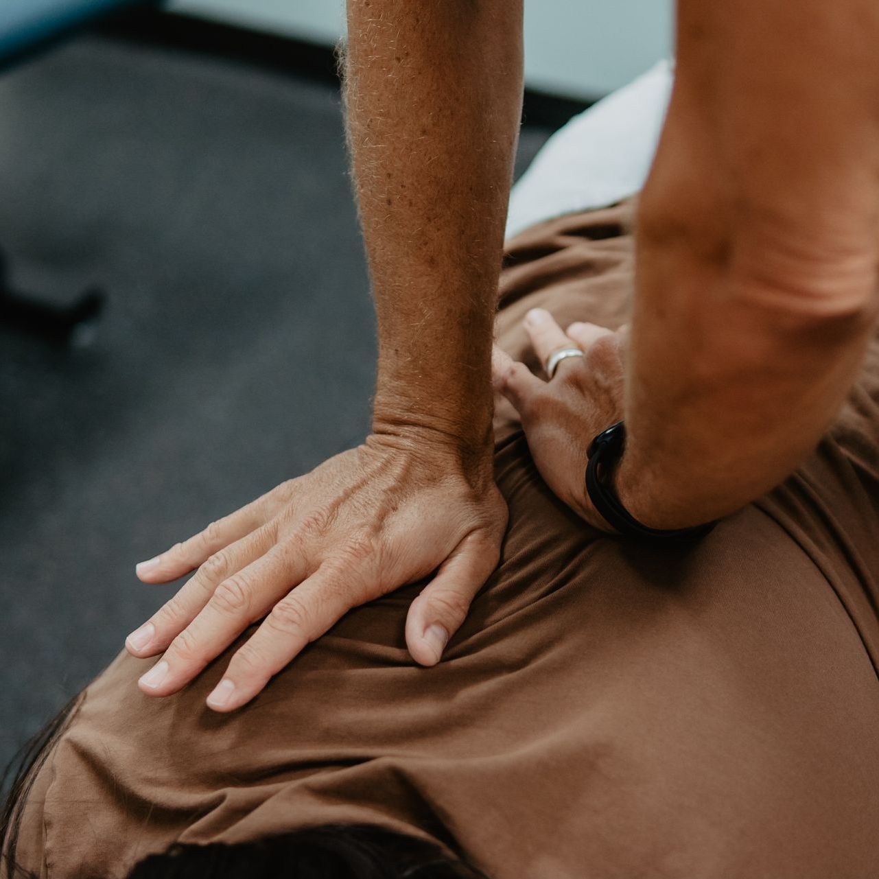 A person is giving a massage to another person 's back.
