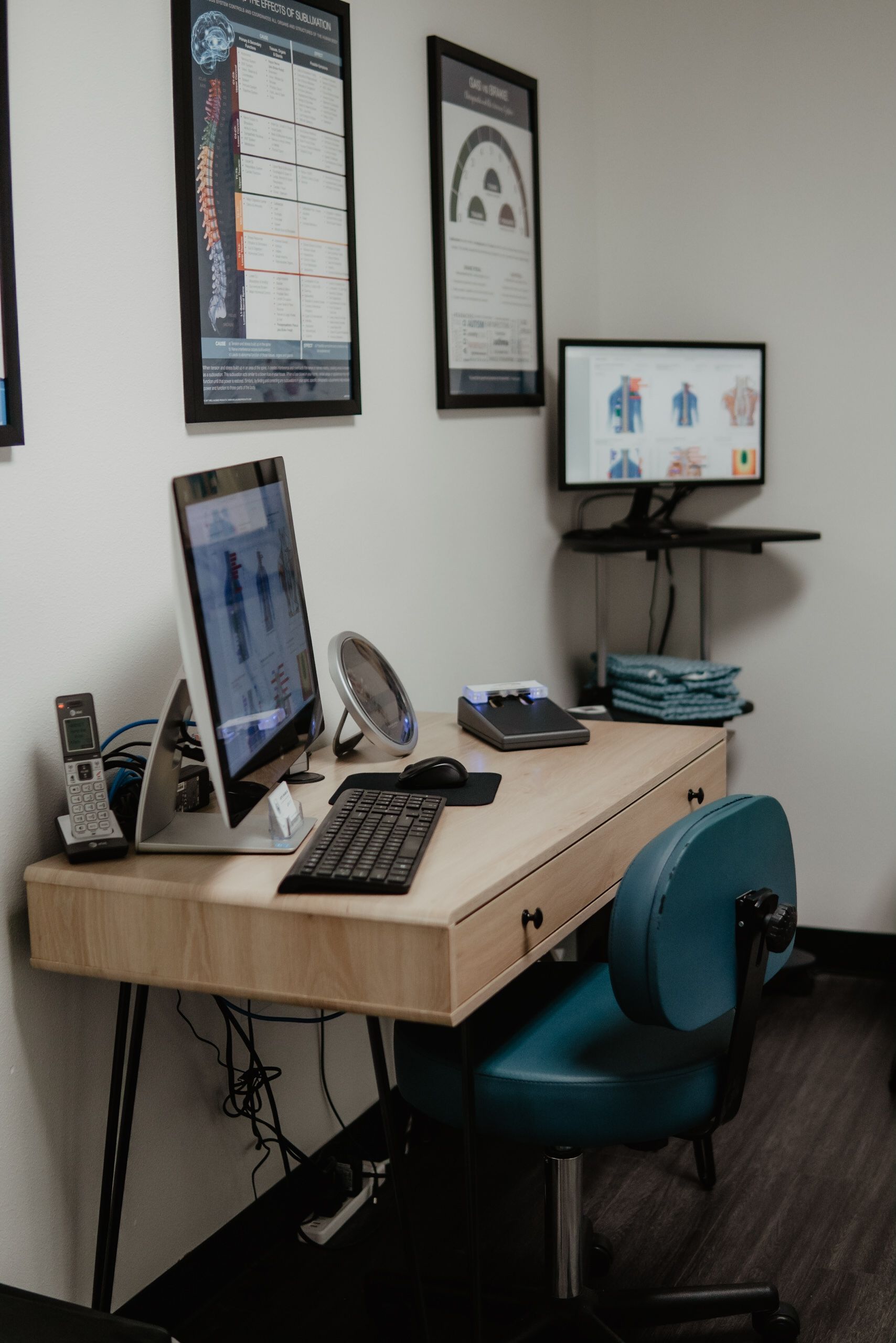 A desk with a computer and a chair in a room.