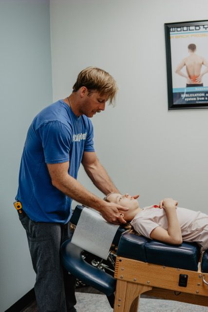 A man is giving a child a massage on a table.