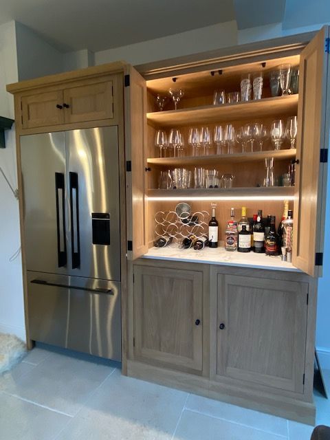 Oak kitchen Fisher Paykel Fridge with bifolds to bar 