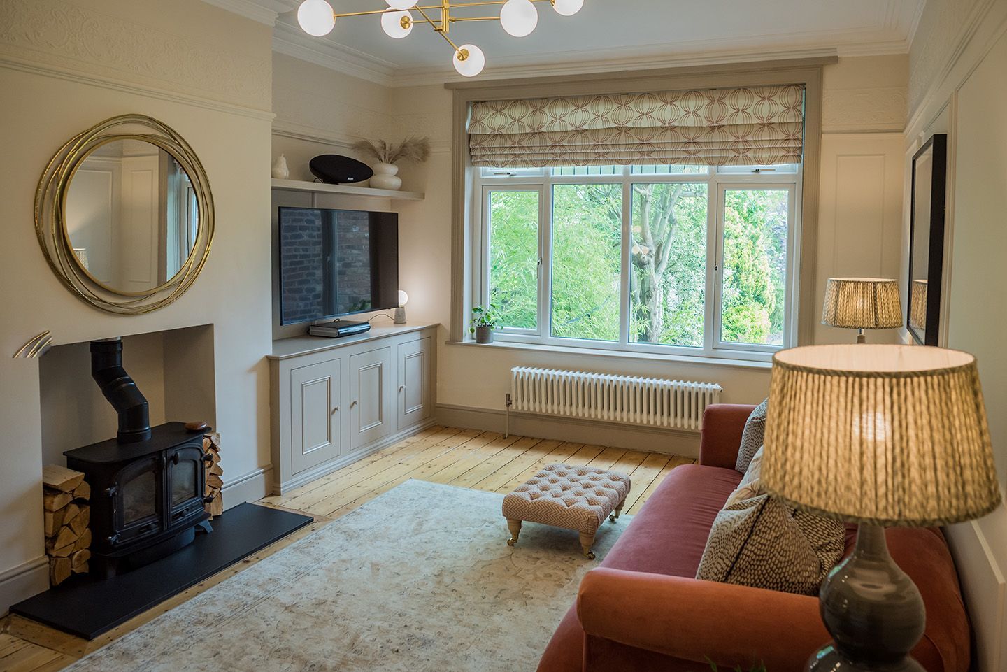 Living room overview in neutral tones  with log burner and built in media unit