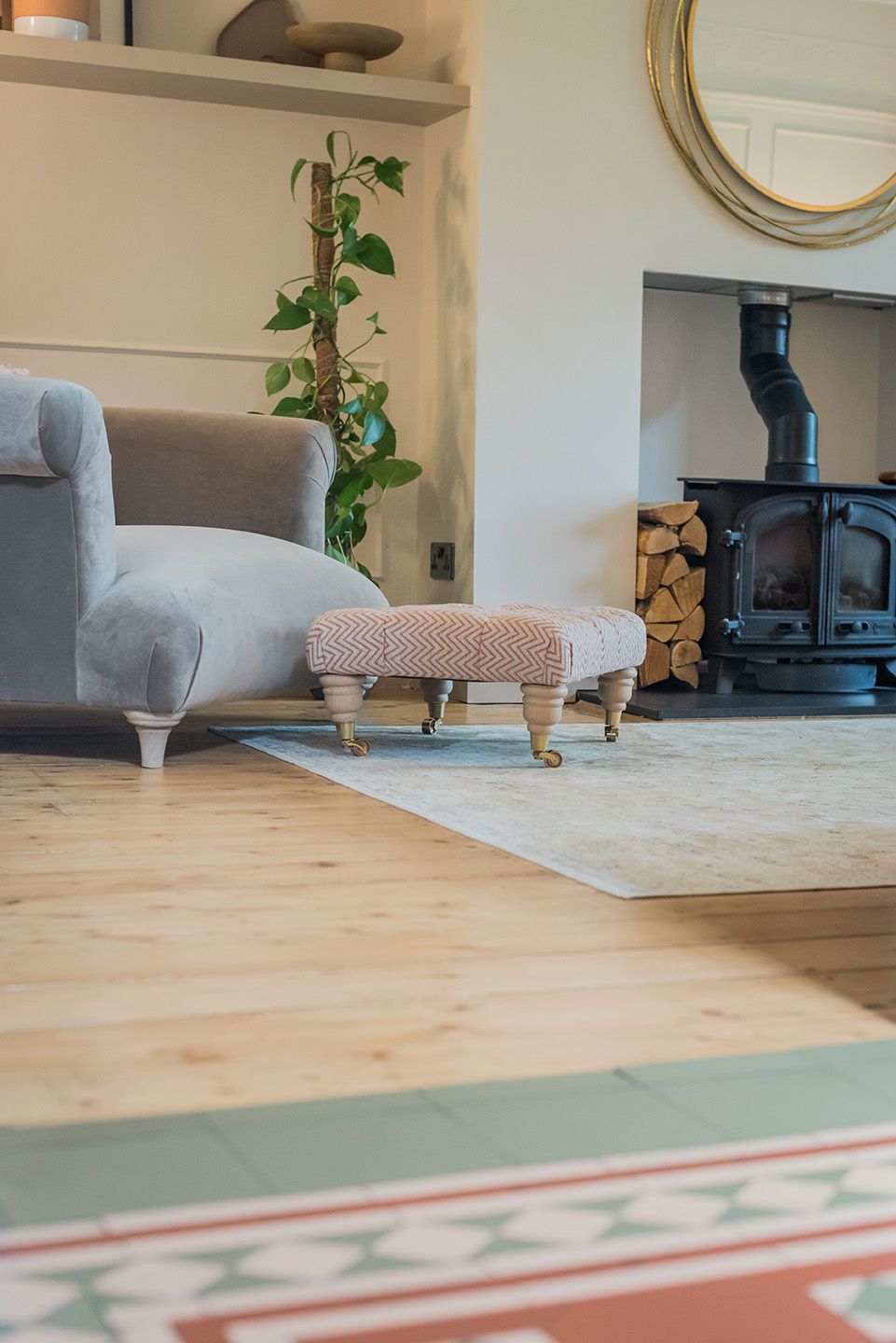 Loaf grey velvet snuggler chair with buttoned footstool and log burner