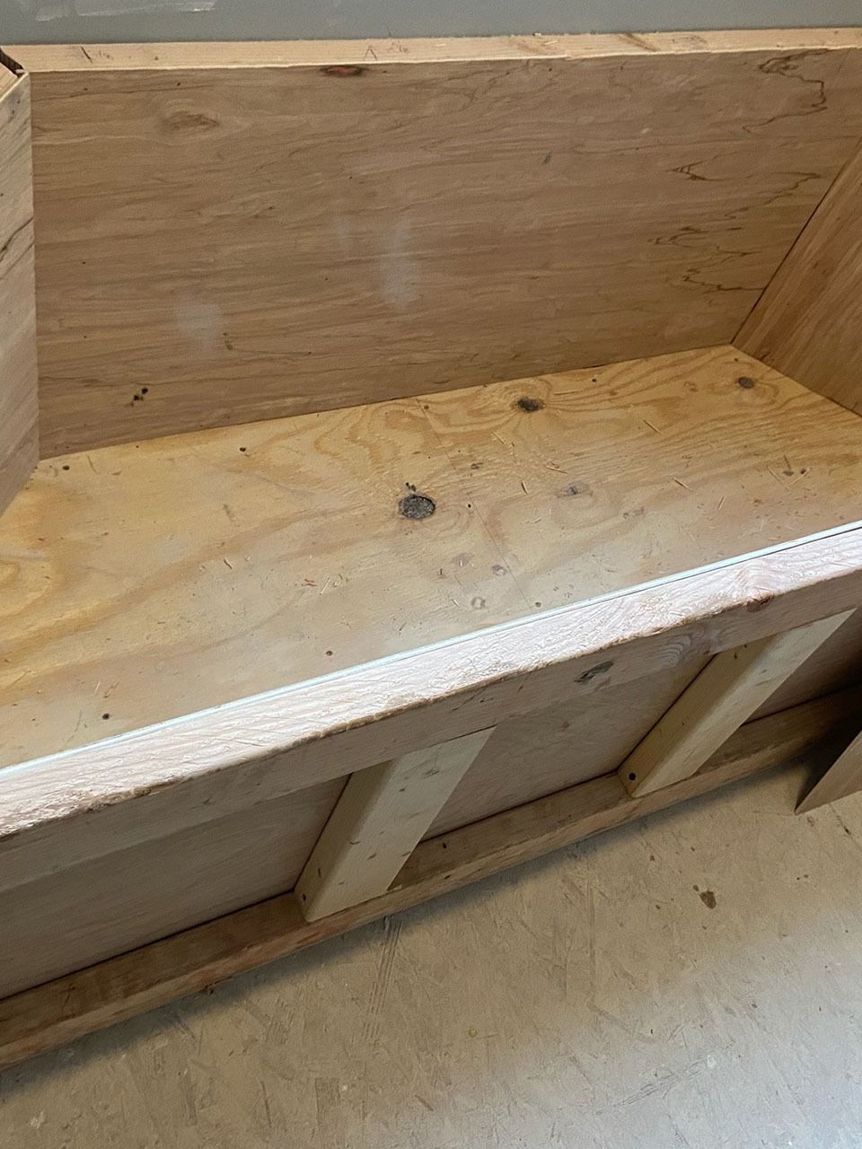 Wooden box with light brown plywood sides and bottom.