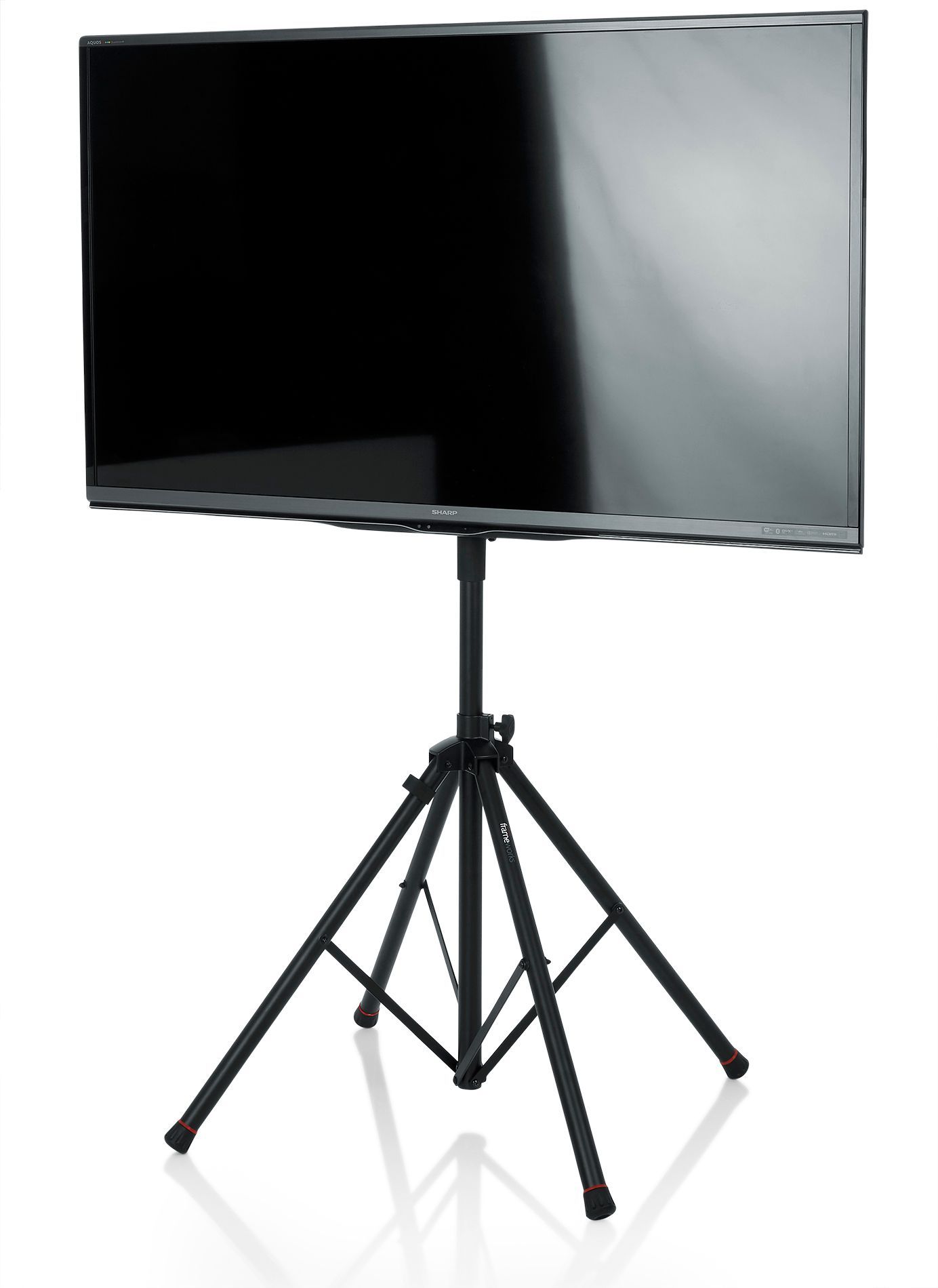 Black flat-screen TV mounted on a black tripod stand, reflecting light.