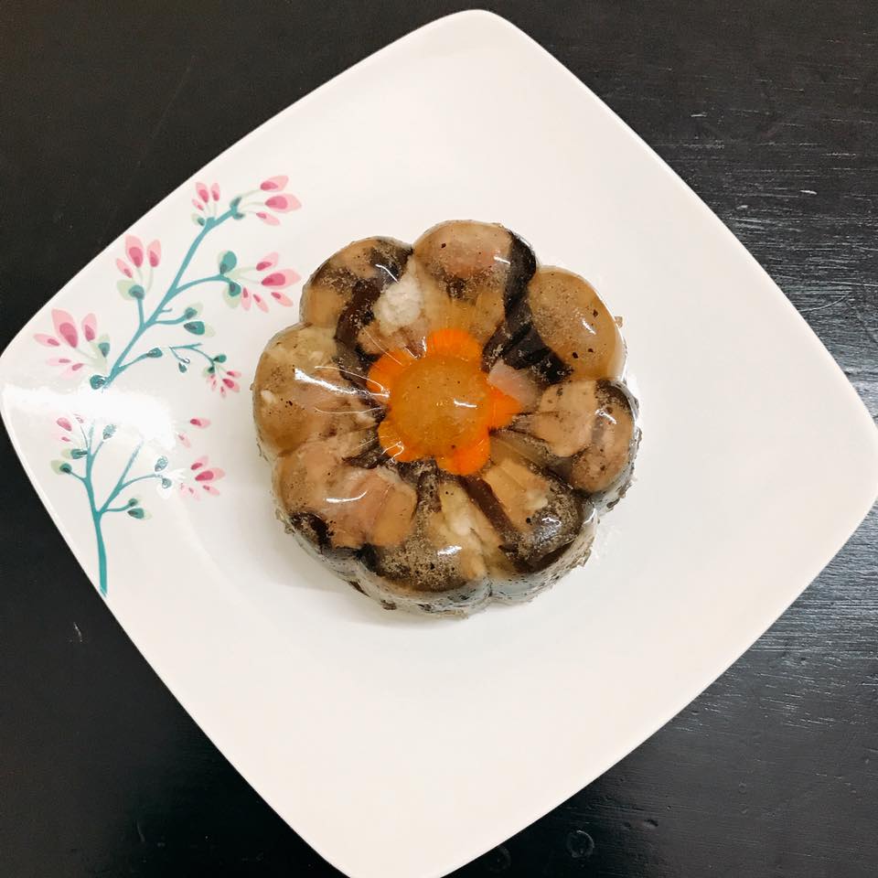 A white plate with a flower shaped food on it