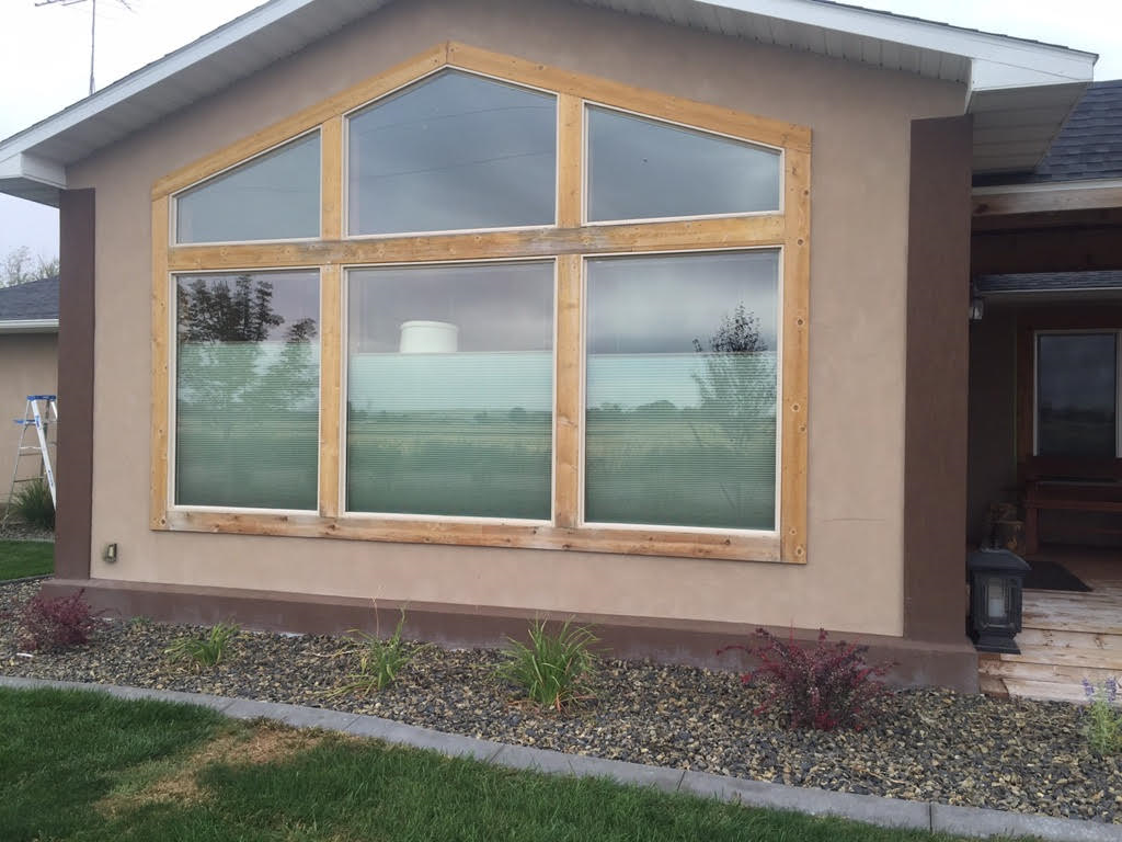 A house with a large window on the side of it