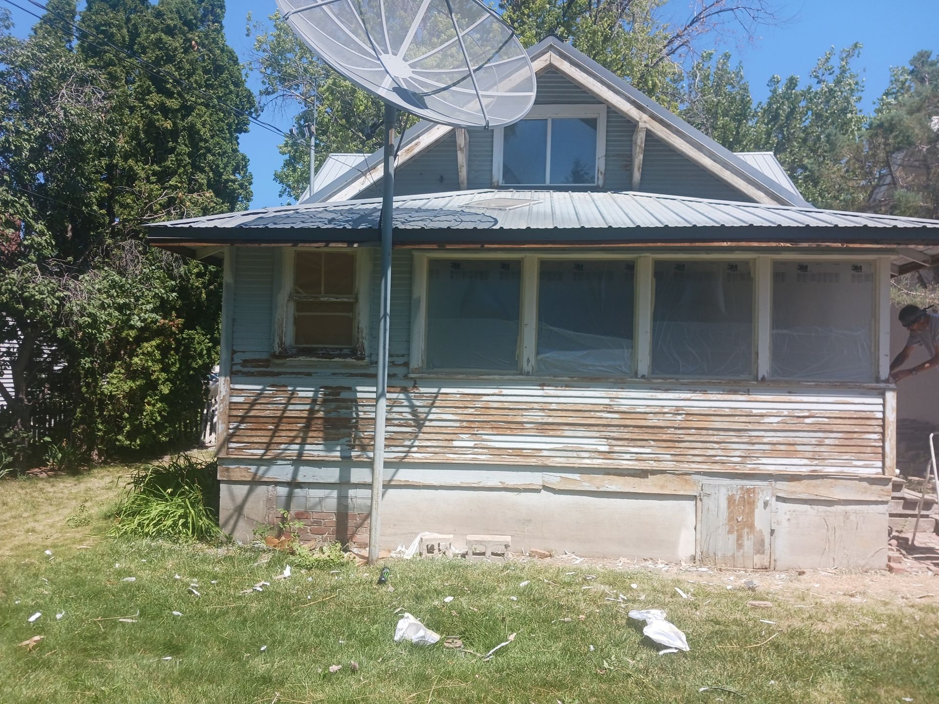 An old house with a satellite dish on top of it