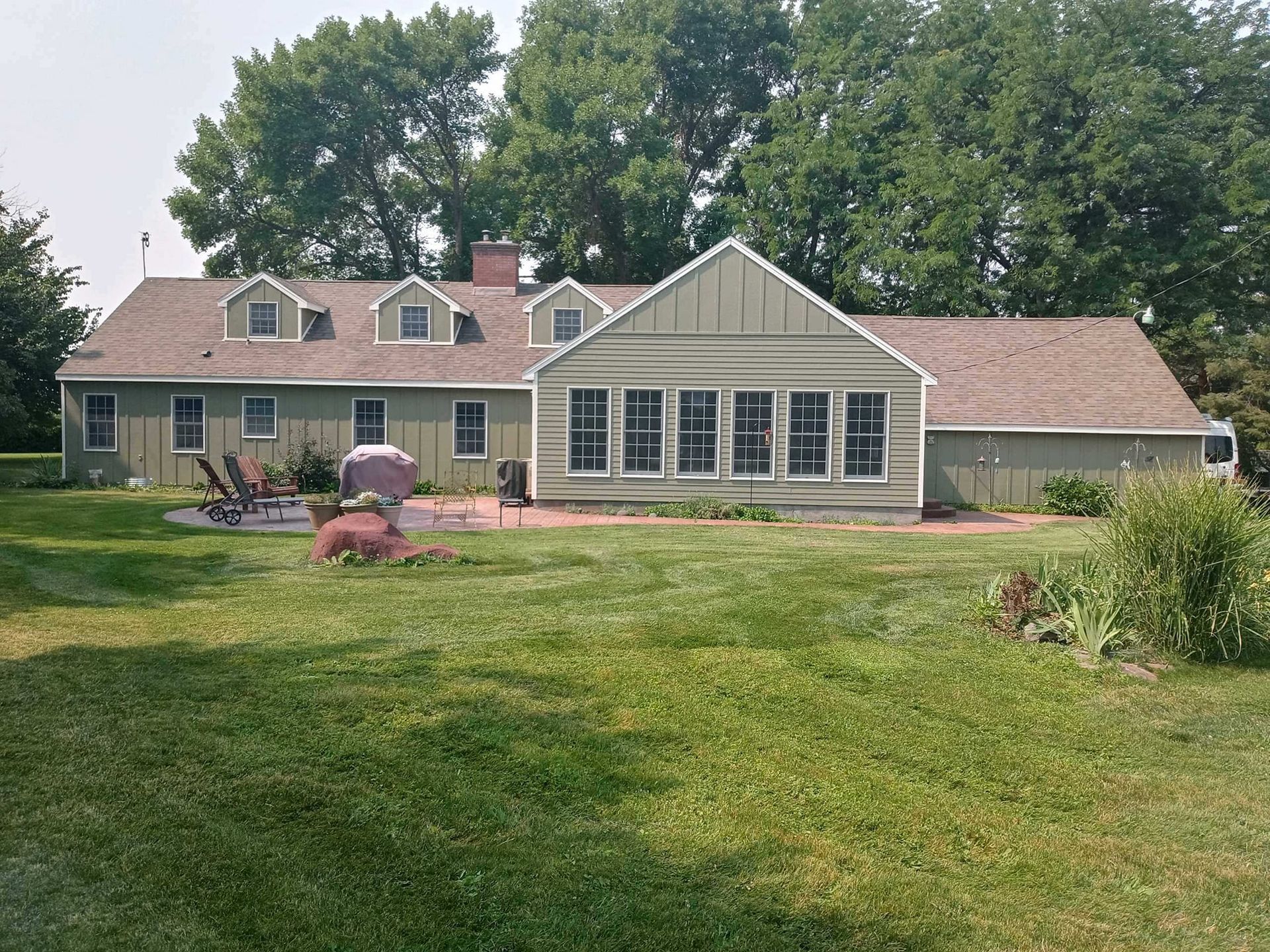A large house with a lawn mower in front of it