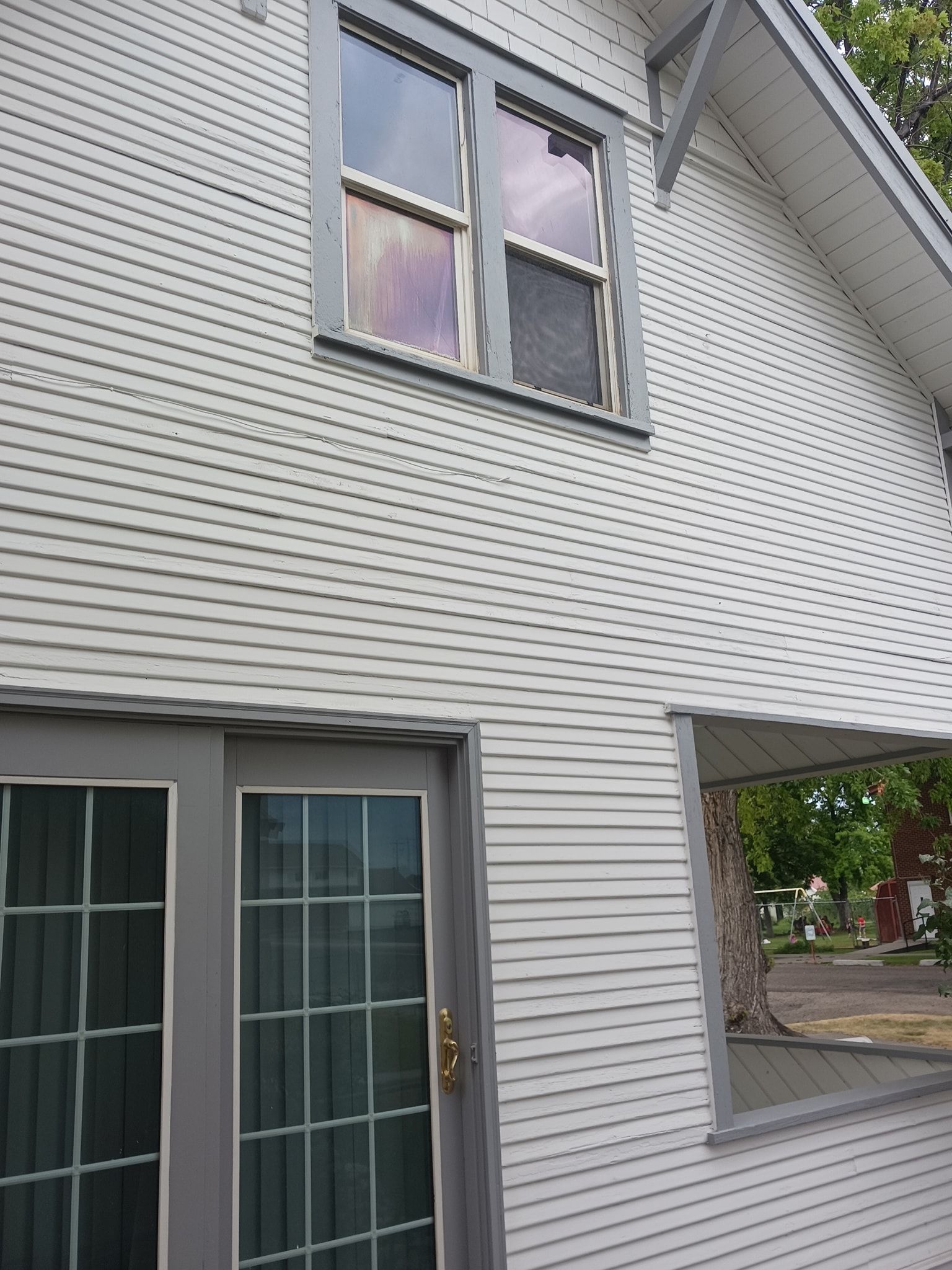A white house with two windows and a door