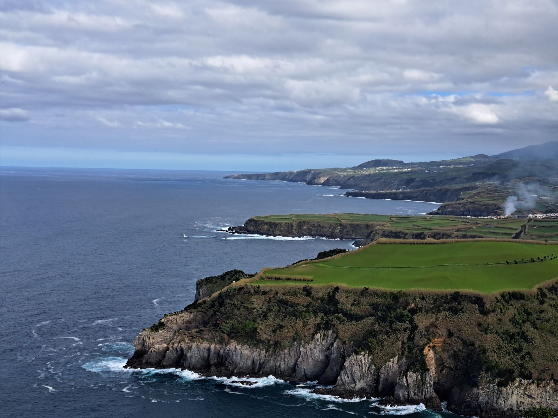 An aerial view of a cliff overlooking the ocean