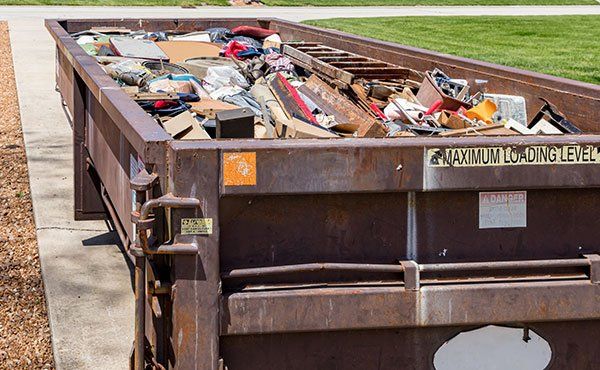 Dumpster With Bricks — Davie, FL — Junk Worxz Junk Removal And Dumpster Rental