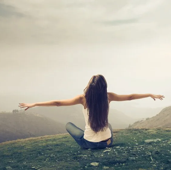 lady or woman is relaxed and feeling free enjoying the nature