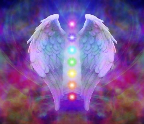 Angel wings and seven chakras on pastel rainbow