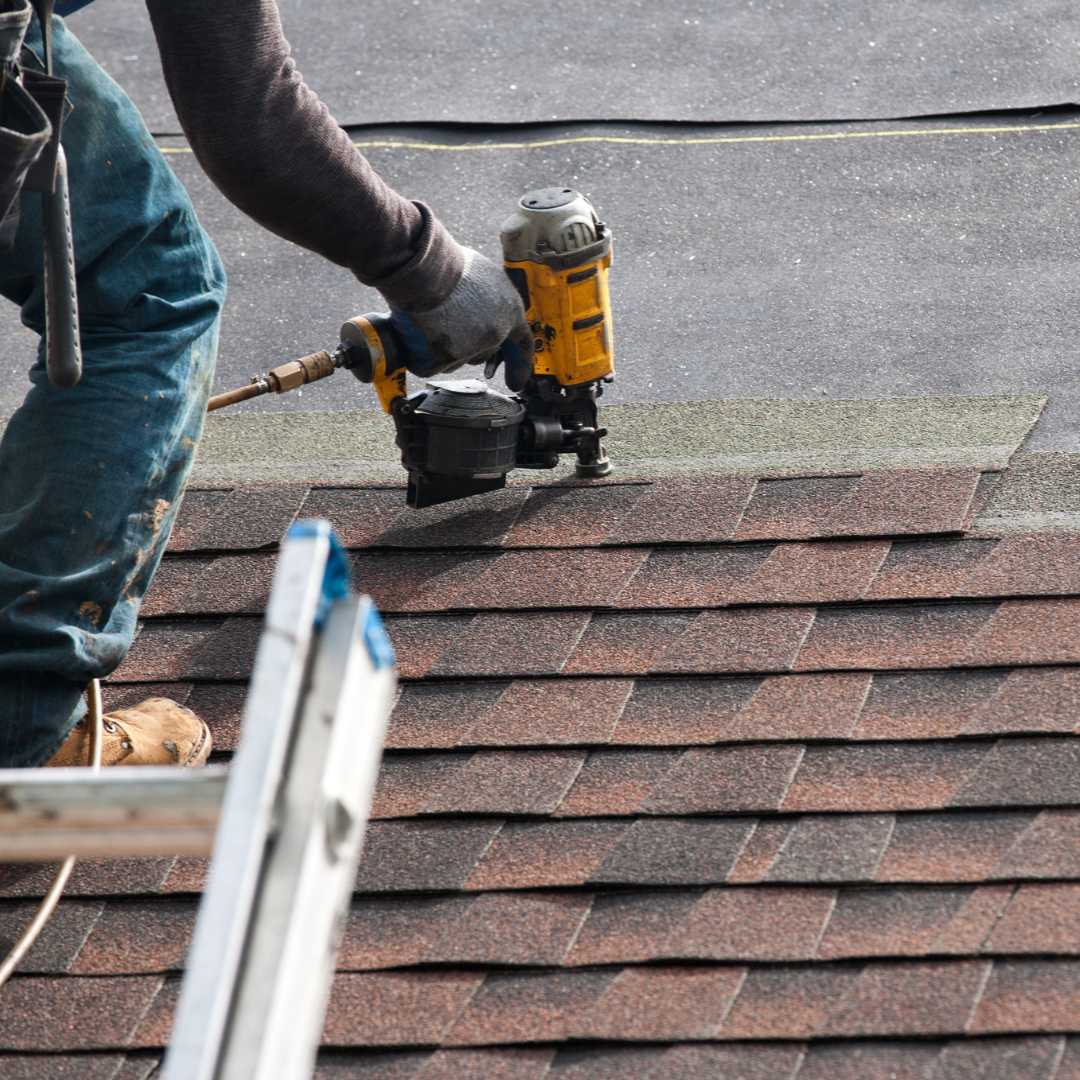 Man with nail gun on Roof