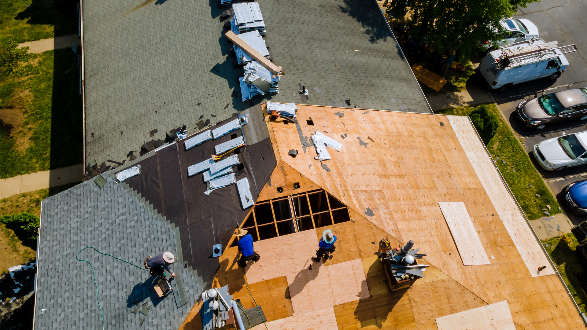 An aerial view of a group of people working on a roof.