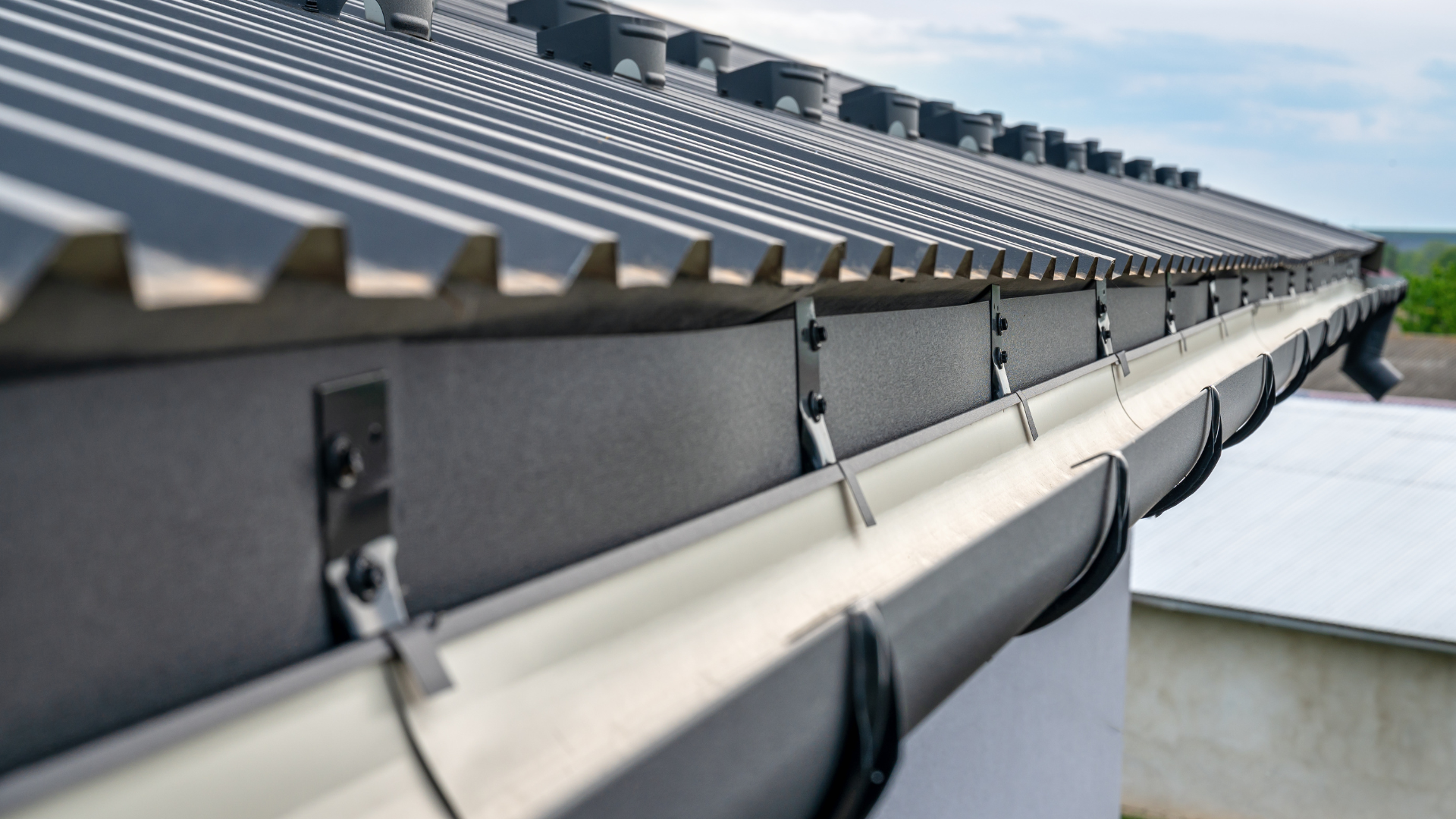 A close up of a gutter on the roof of a building.