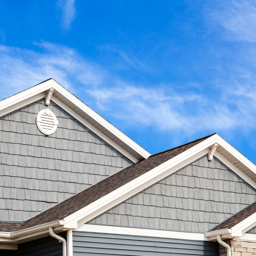 The roof of a house with a blue sky in the background