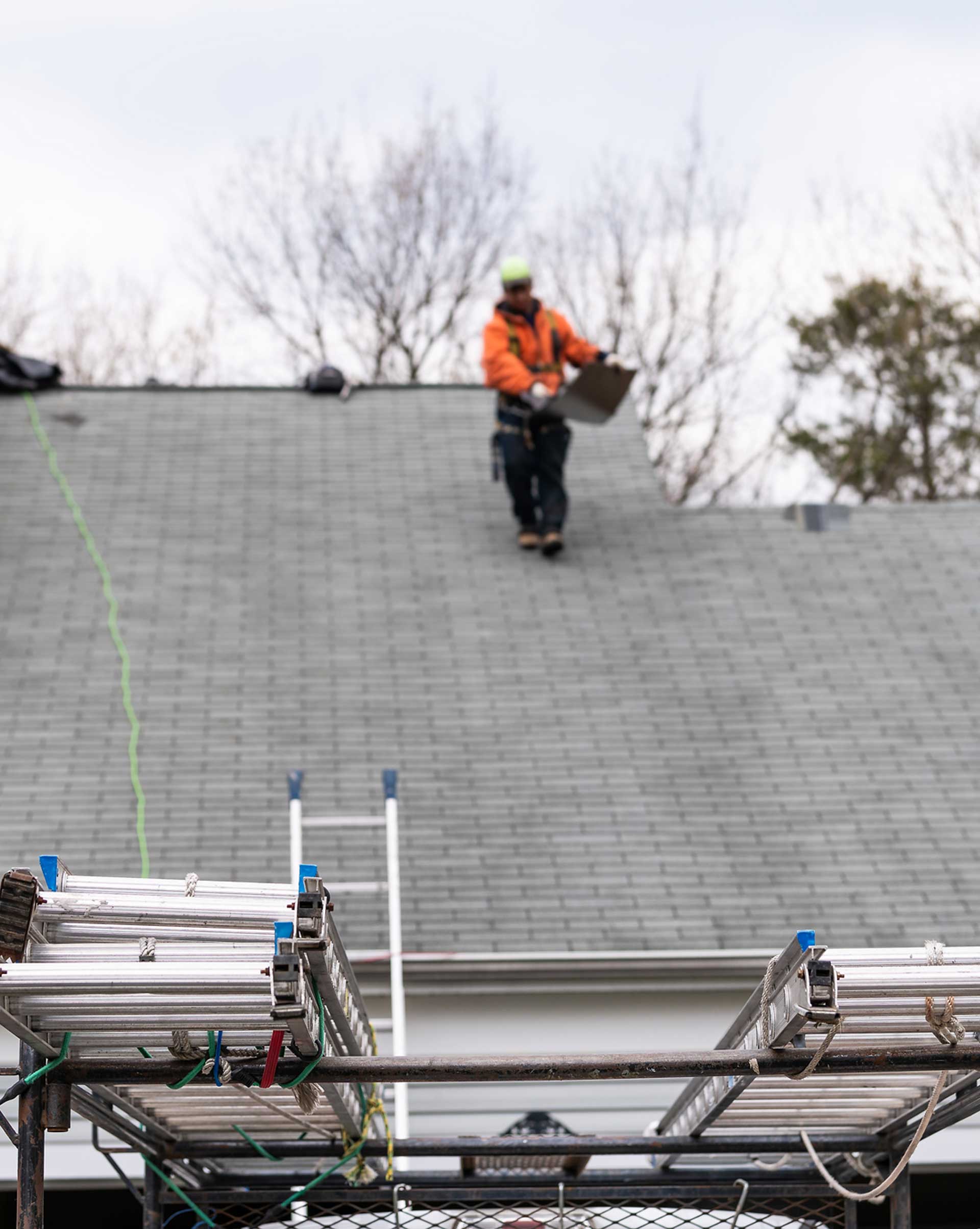 Worker Walking on the Roof — Powells Point, NC — Coastal Roofing & Siding Inc