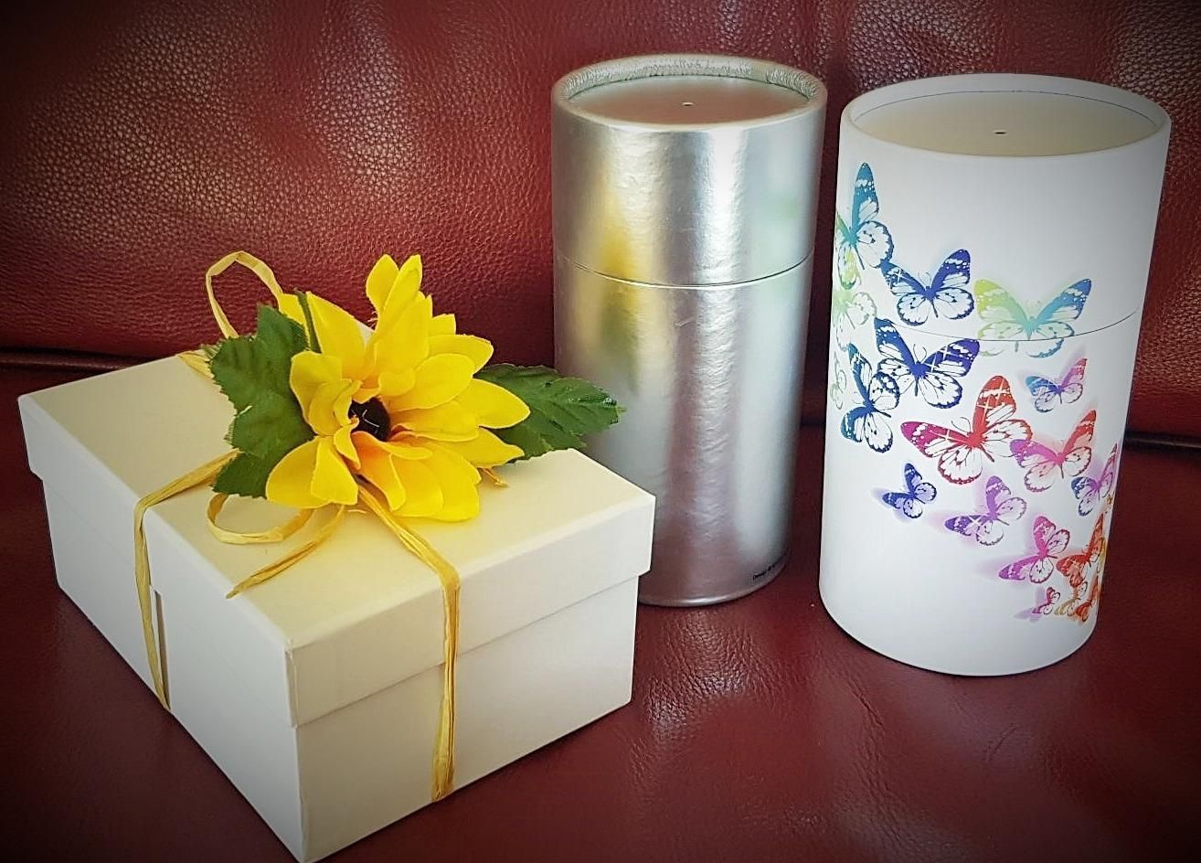 A Gift Box With A Yellow Flower And A Candle With Butterflies On It — Angels for Pets In Tanby, QLD
