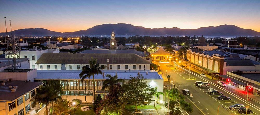 An Aerial View Of A City At Night With Mountains In The Background — Angels for Pets In Rockhampton, QLD