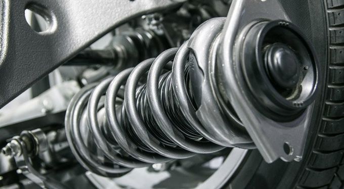 A close up of a shock absorber on a car.