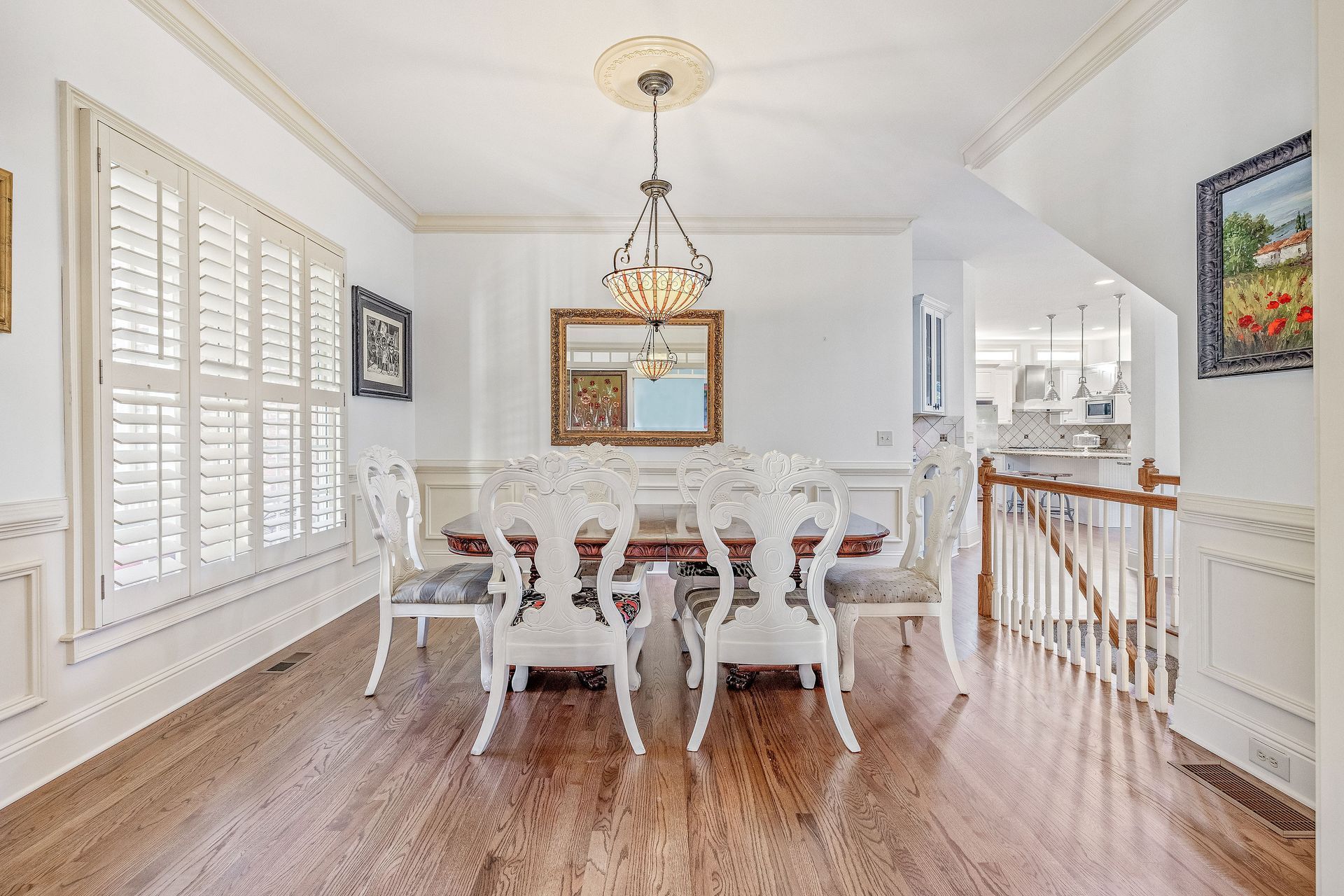 Two women are decorating a christmas tree in a living room.