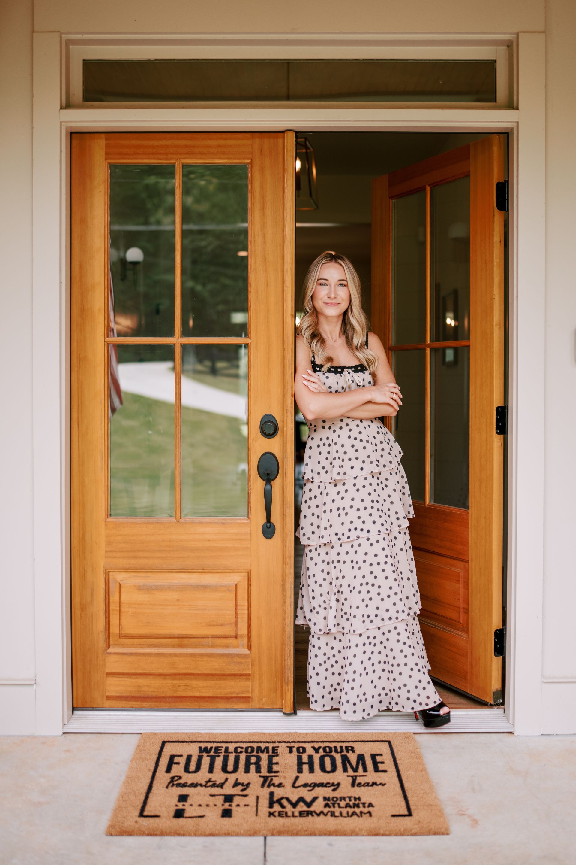 A dining room with a table and chairs and a wooden staircase.