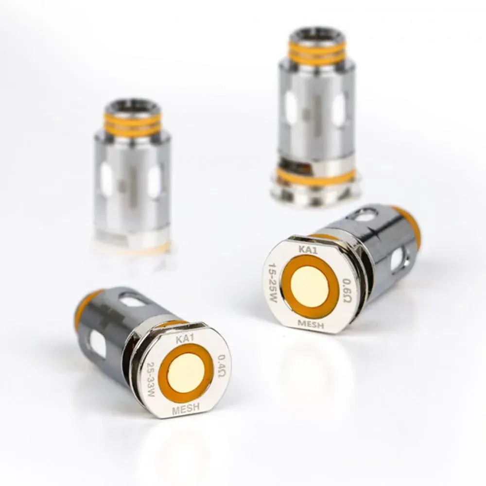 Four vape coils, metallic silver with orange accents, lying and standing on a white surface.
