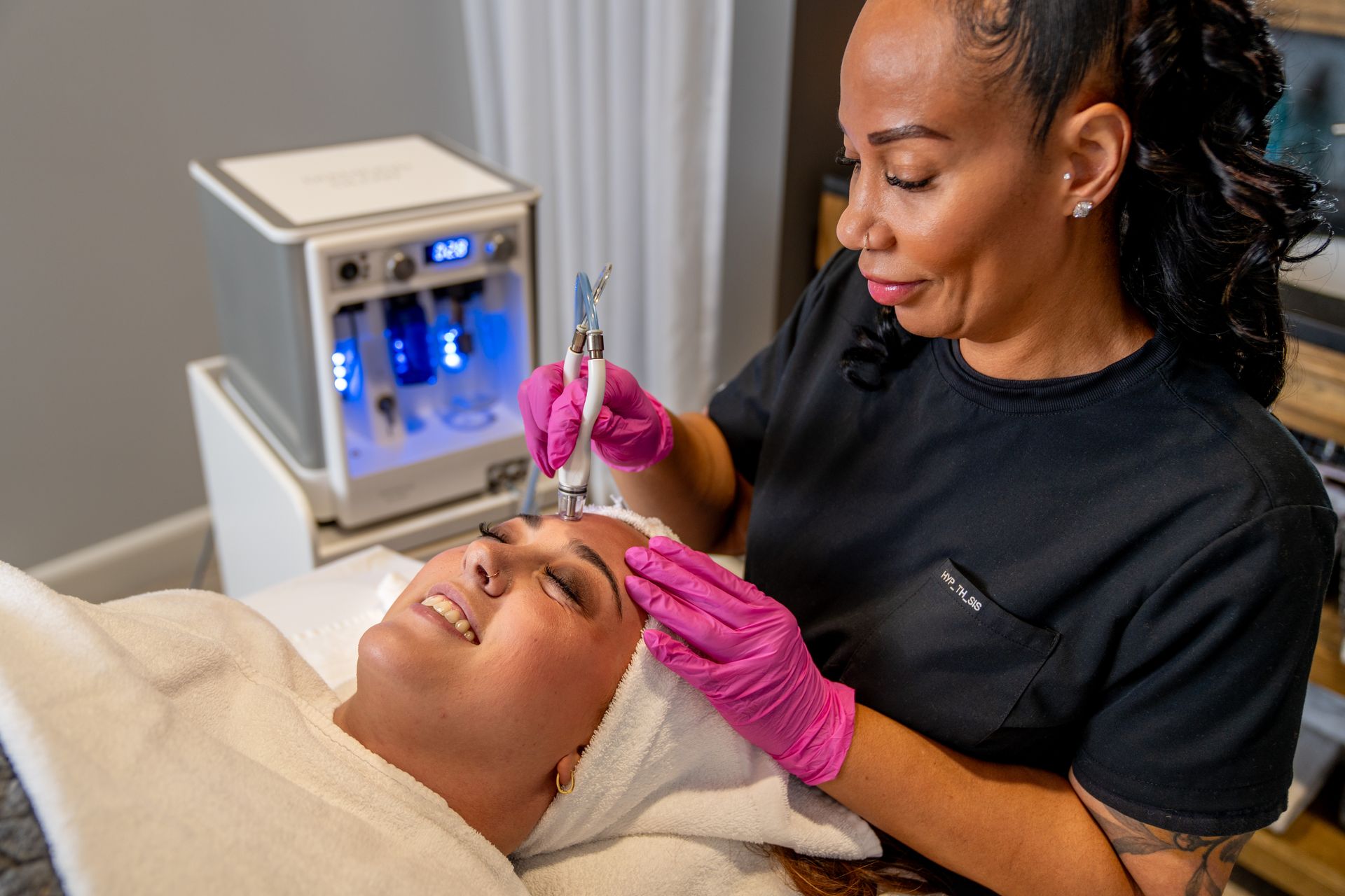 A woman is smiling with her eyes closed and her mouth open.