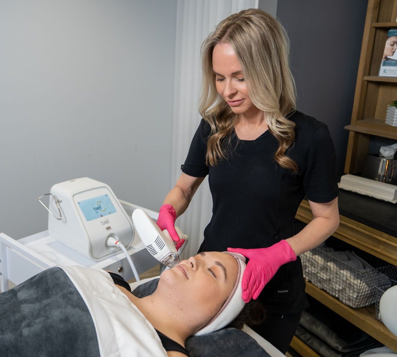 A woman is getting a facial treatment at a beauty salon.