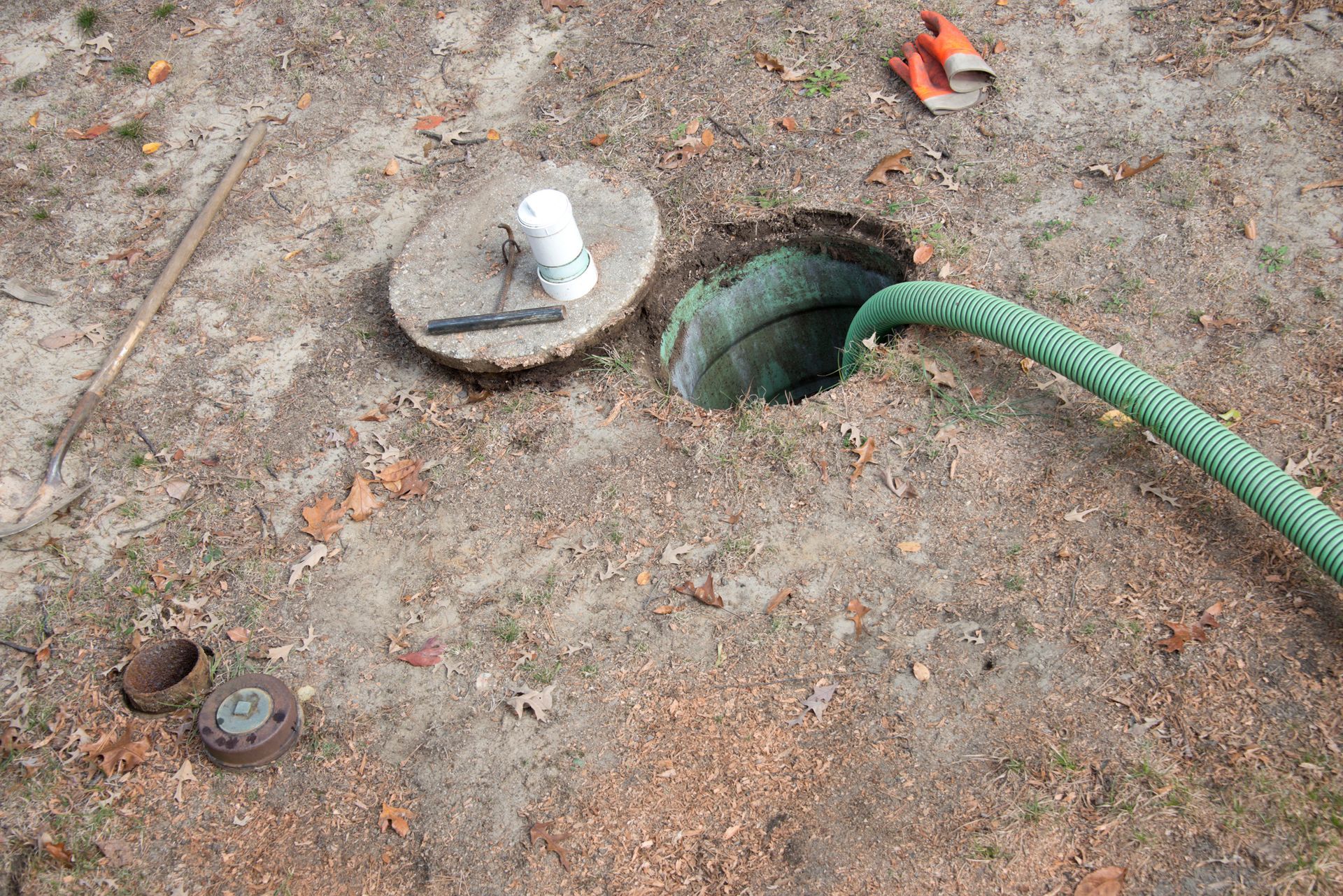 Open access port showcasing cesspool cleaning during septic tank maintenance and inspection.