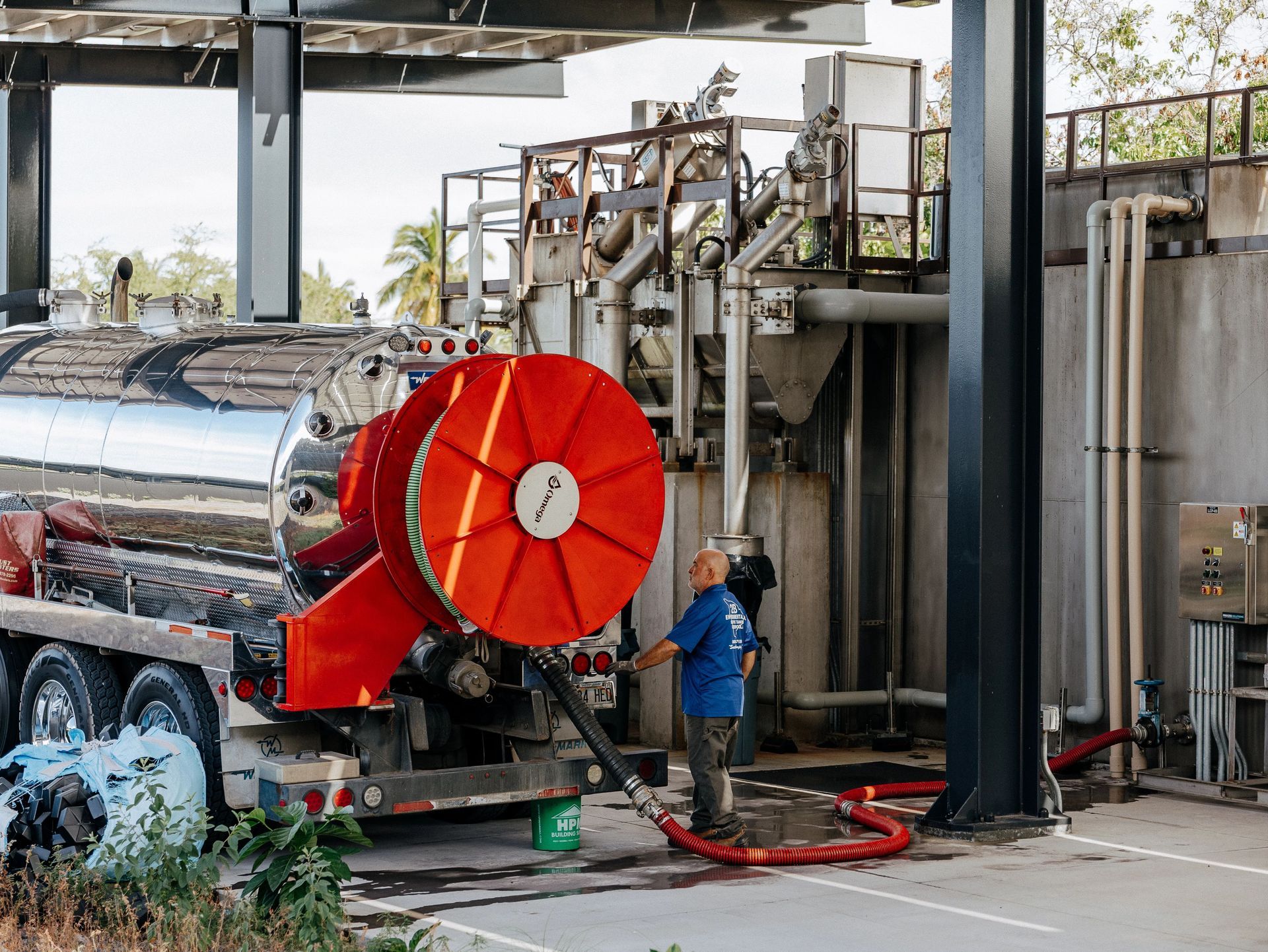A technician walking a property with blueprints in hand and a client by their side.