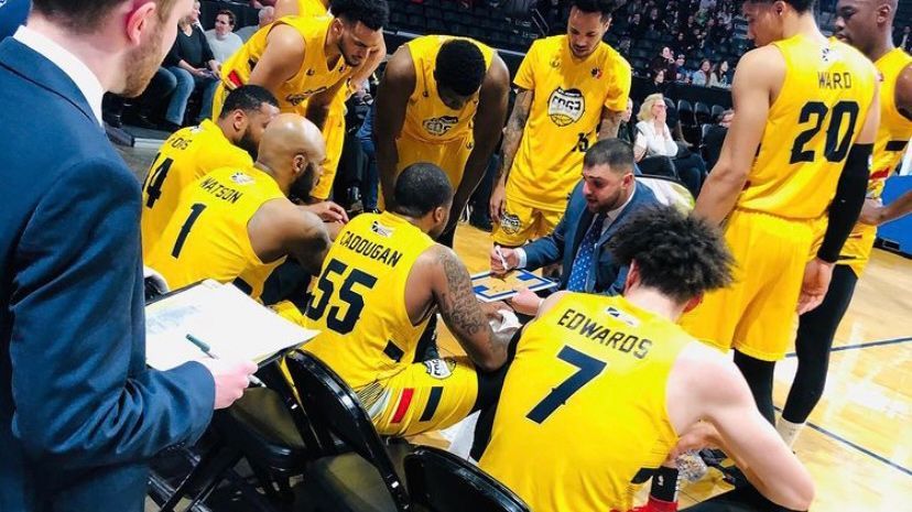 Steven Marcus Coaching a basketball play in timeout 