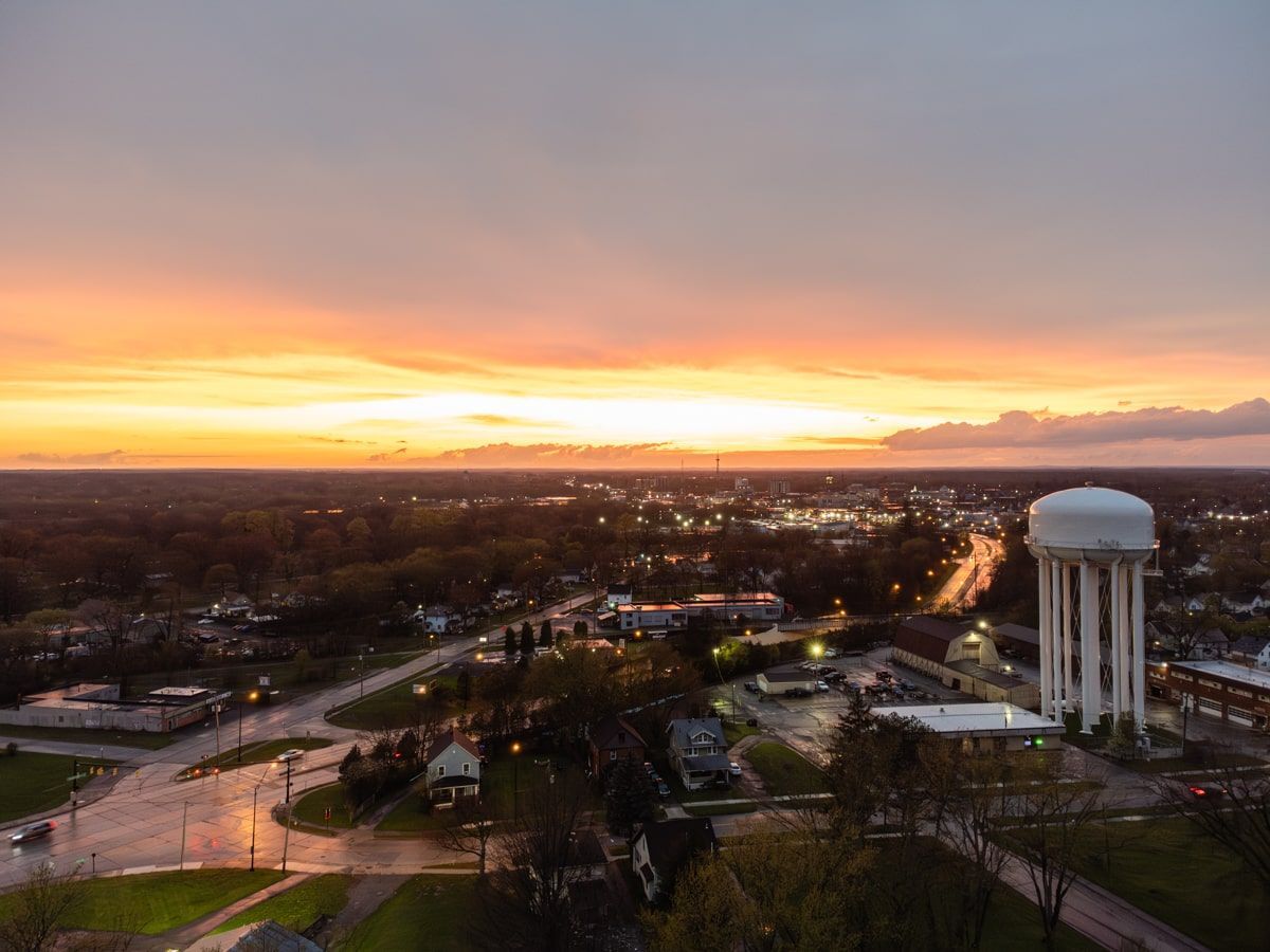 City of Warren, Ohio, golden sunset with water tower in foreground. 