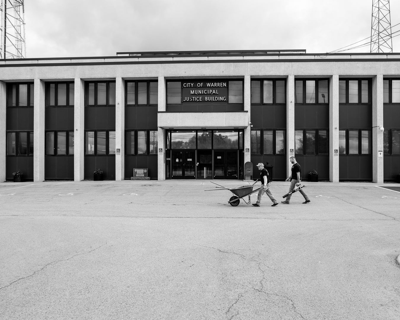 Behind-the-scenes photo of City of Warren off-duty police officers volunteering to beautify the Municipal Building. 