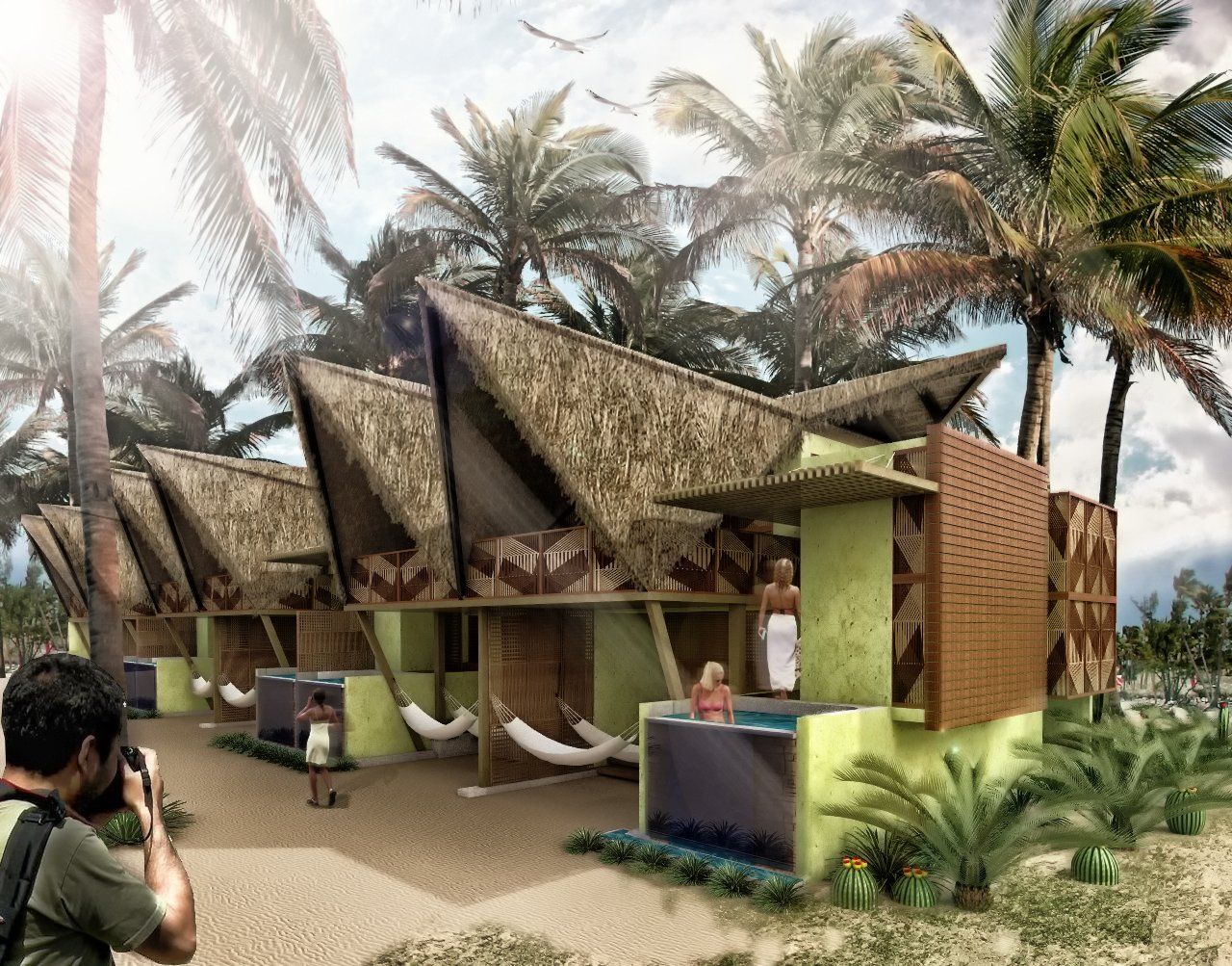 Un hombre está tomando una fotografía de un edificio con techo de paja en la playa.