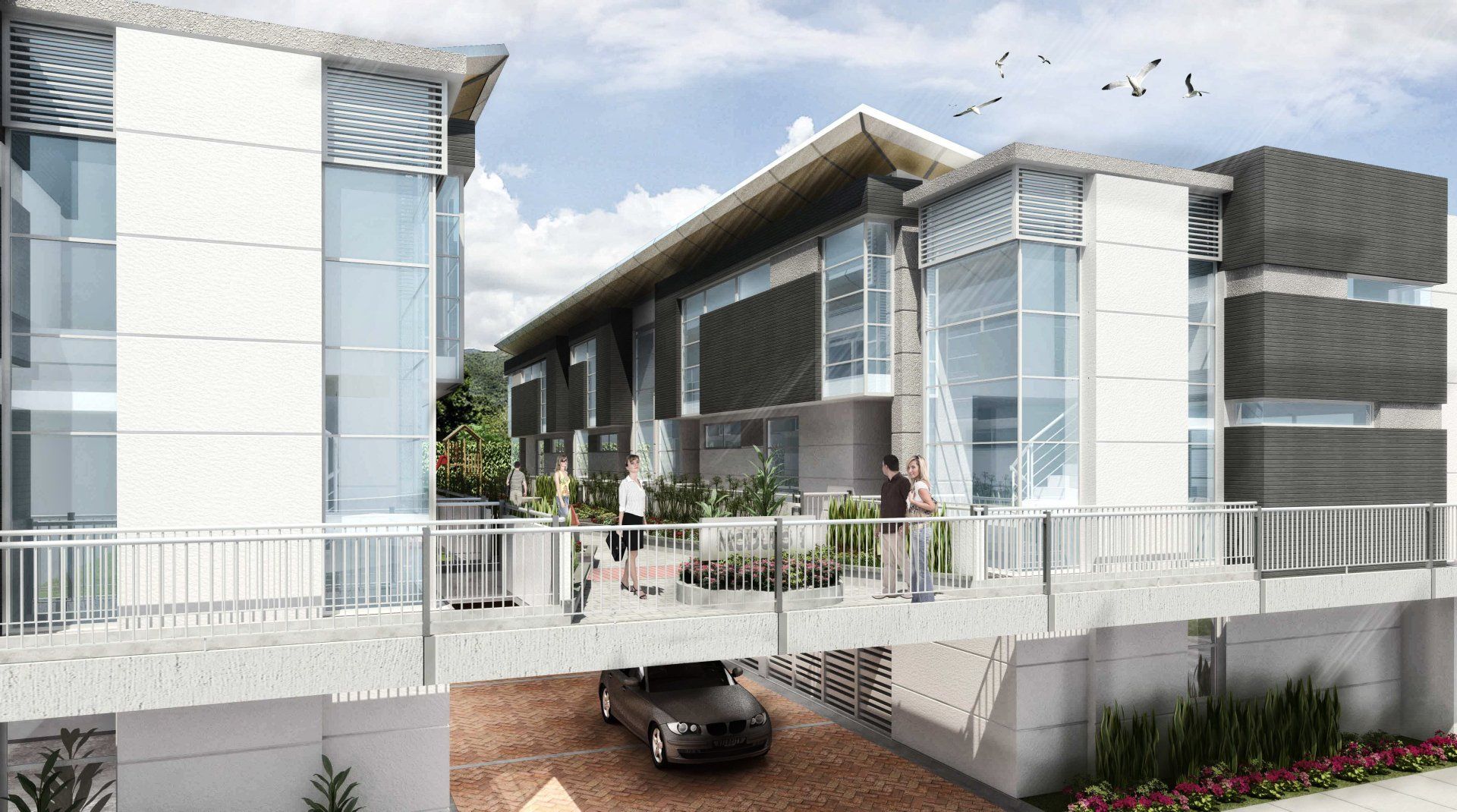 Un auto está estacionado debajo de un puente frente a un edificio.