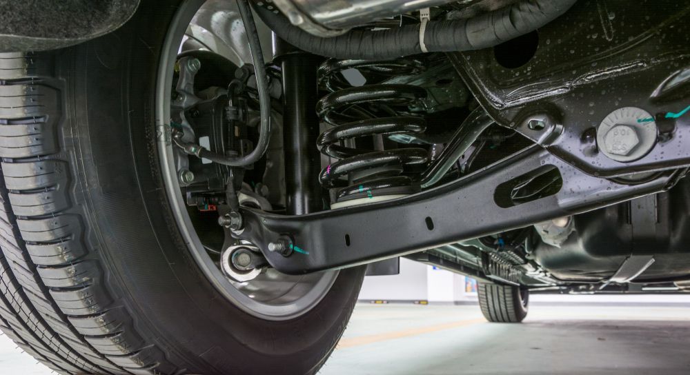 A Close Up of the Underside of a Car With a Tire and Shock Absorber — Turbo's Tyres Pty Ltd In Humpty Doo, NT