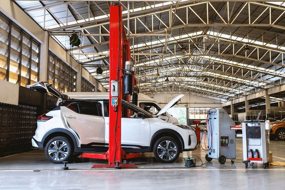 A Car is Sitting on a Lift in a Garage — Turbo's Tyres Pty Ltd In Palmerston, NT