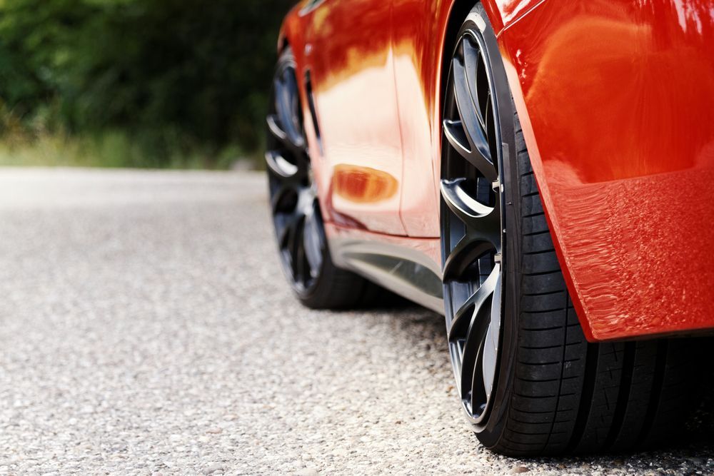 A Red Sports Car is Parked on the Side of the Road — Turbo's Tyres Pty Ltd In Humpty Doo, NT