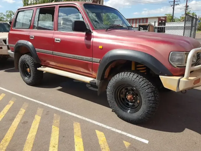 A Red Toyota Land Cruiser is Parked in a Parking Lot — Turbo's Tyres Pty Ltd In Humpty Doo, NT