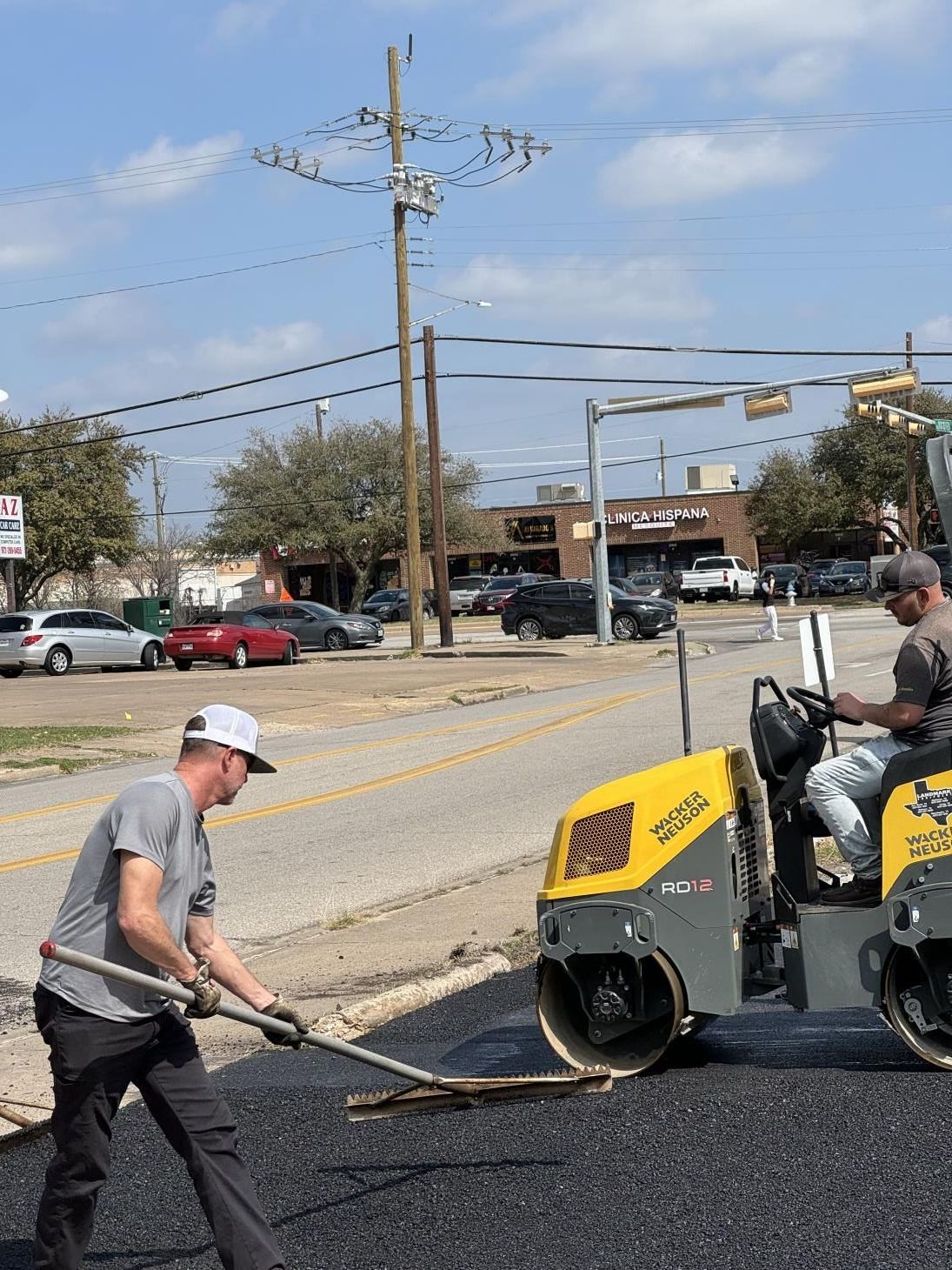 Image of workers repairing a damaged asphalt road, using tools to fill cracks and smooth the surface, ensuring safe and smooth transportation.