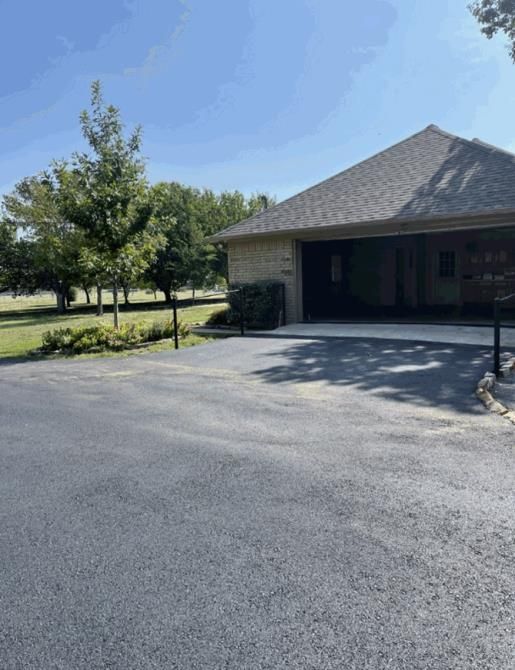 A charming suburban family home with an asphalt driveway leading up to the house.