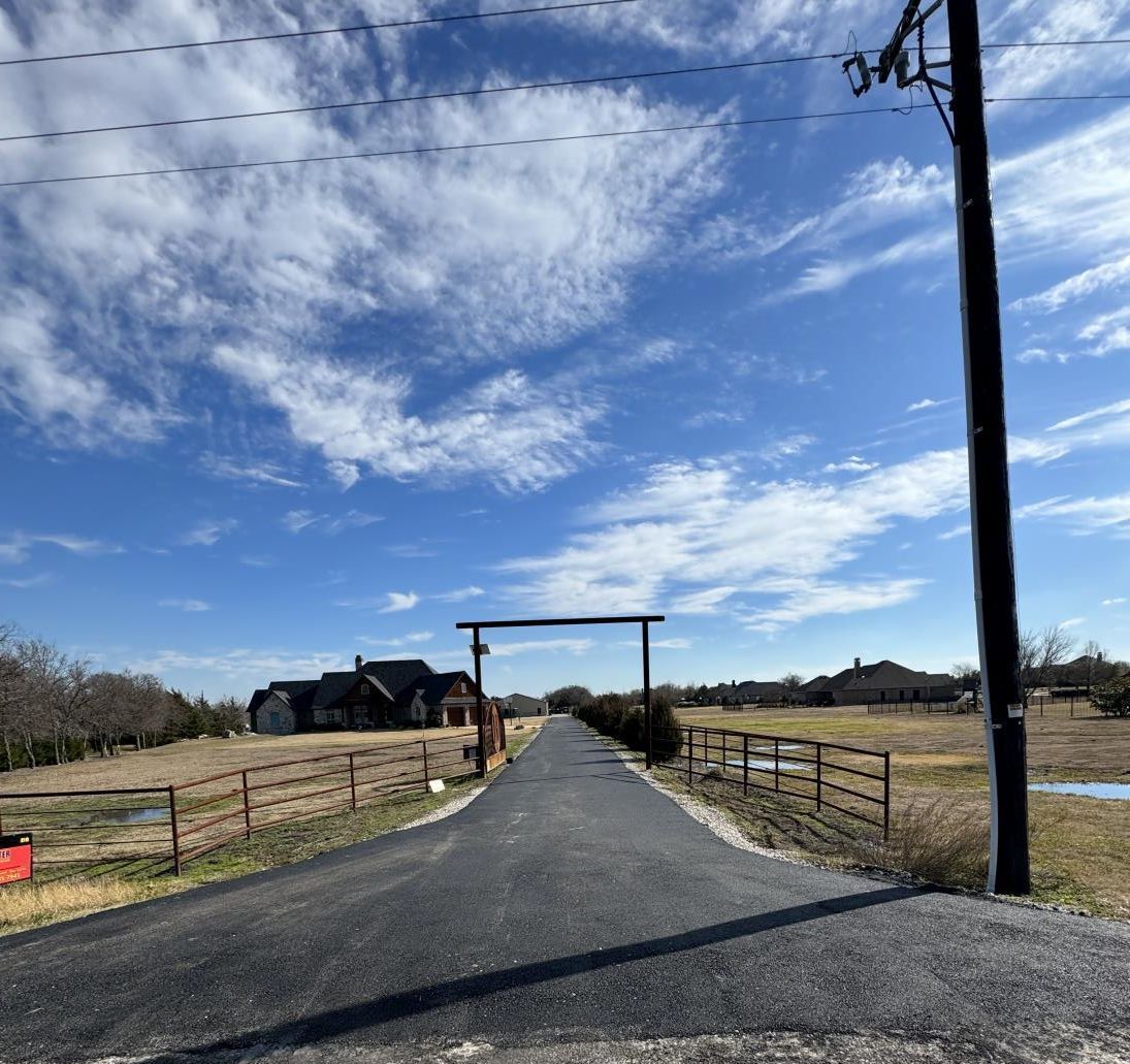 An asphalt driveway being sealed to protect and extend its lifespan.