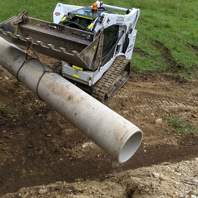 Excavator with Pipe — Earthmoving Services  in Eungai Creek, NSW