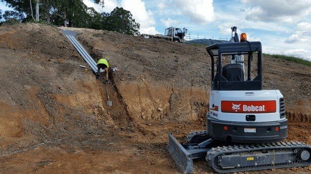 Man Fixing Pipe — Earthmoving Services  in Eungai Creek, NSW