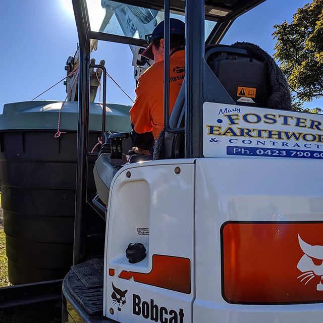 Man in Orange Clothes Excavating — Earthmoving Services  in Eungai Creek, NSW