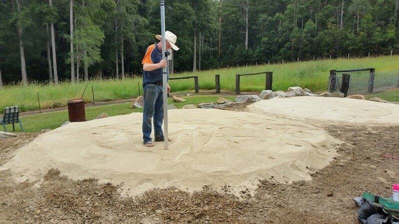 Man Standing on Sand — Earthmoving Services  in Eungai Creek, NSW