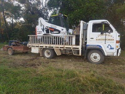 White Truck with Excavator — Earthmoving Services  in Eungai Creek, NSW